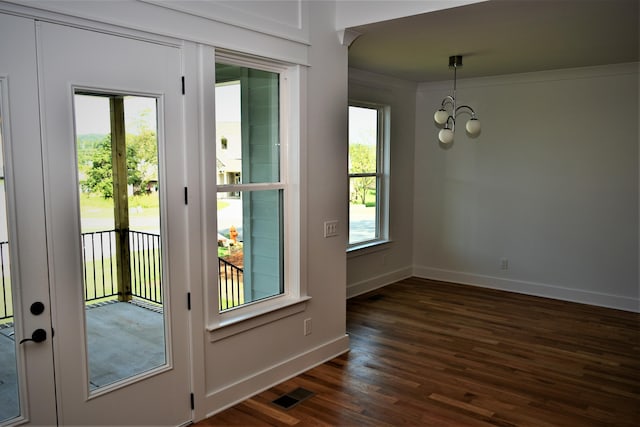 entryway featuring french doors, dark wood finished floors, a notable chandelier, visible vents, and baseboards