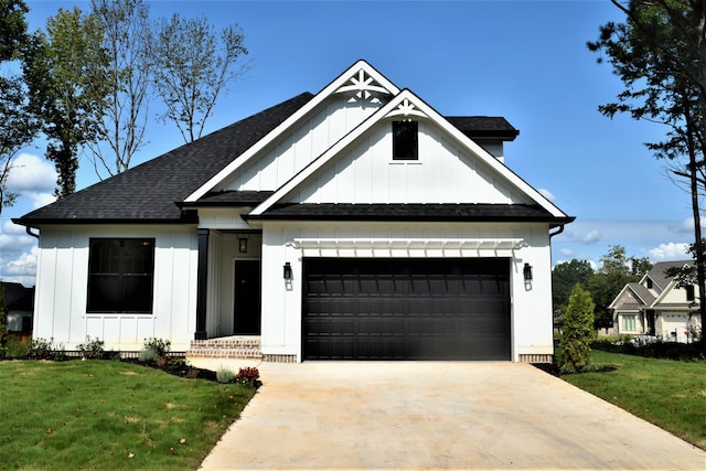 modern farmhouse featuring a garage, driveway, and board and batten siding