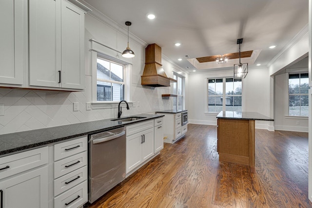 kitchen featuring pendant lighting, white cabinetry, stainless steel dishwasher, and sink