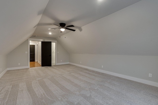 additional living space featuring ceiling fan, light carpet, and vaulted ceiling