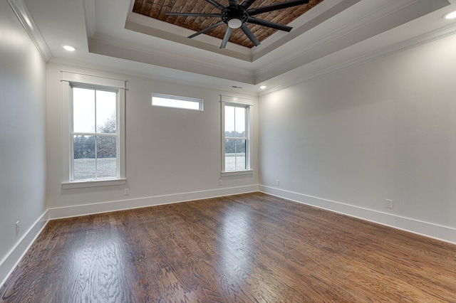 spare room featuring a raised ceiling, crown molding, ceiling fan, and dark hardwood / wood-style floors