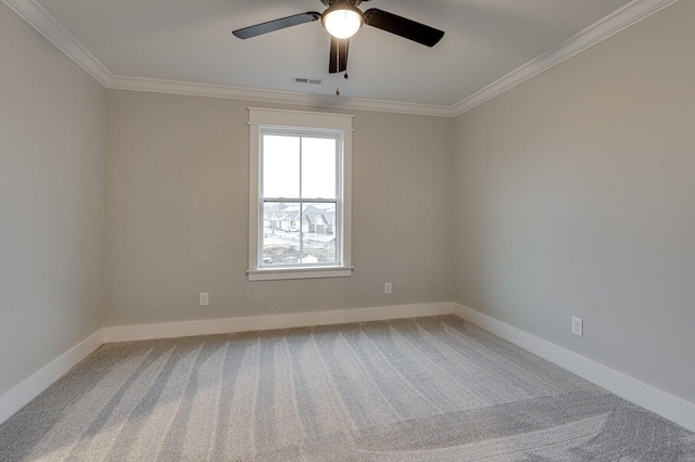 carpeted spare room with ceiling fan and crown molding