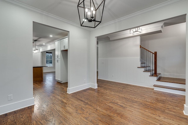 interior space featuring crown molding, dark hardwood / wood-style flooring, and a chandelier