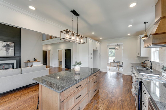 111 Arthur Ln NW, Cleveland, TN 37312 - kitchen with a sink, range with two ovens, crown molding, dark stone countertops, and dark wood-style floors