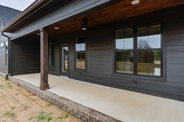 doorway to property with ceiling fan and a porch