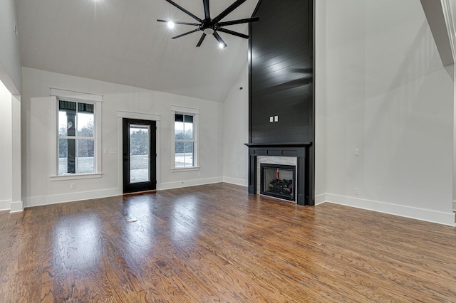 unfurnished living room featuring high vaulted ceiling, ceiling fan, a fireplace, beamed ceiling, and wood-type flooring