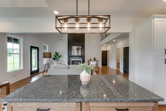 111 Arthur Ln NW, Cleveland, TN 37312 - kitchen featuring crown molding, open floor plan, wood finished floors, white cabinets, and dark stone countertops