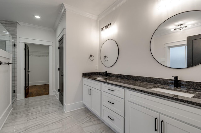 bathroom featuring vanity, a shower with shower door, and crown molding