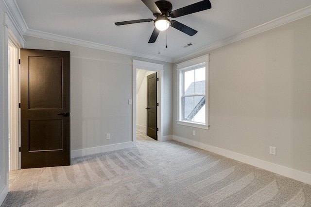 unfurnished bedroom with light colored carpet, ceiling fan, and crown molding