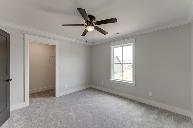 111 Arthur Ln NW, Cleveland, TN 37312 - unfurnished bedroom with a walk in closet, light colored carpet, ornamental molding, baseboards, and ceiling fan