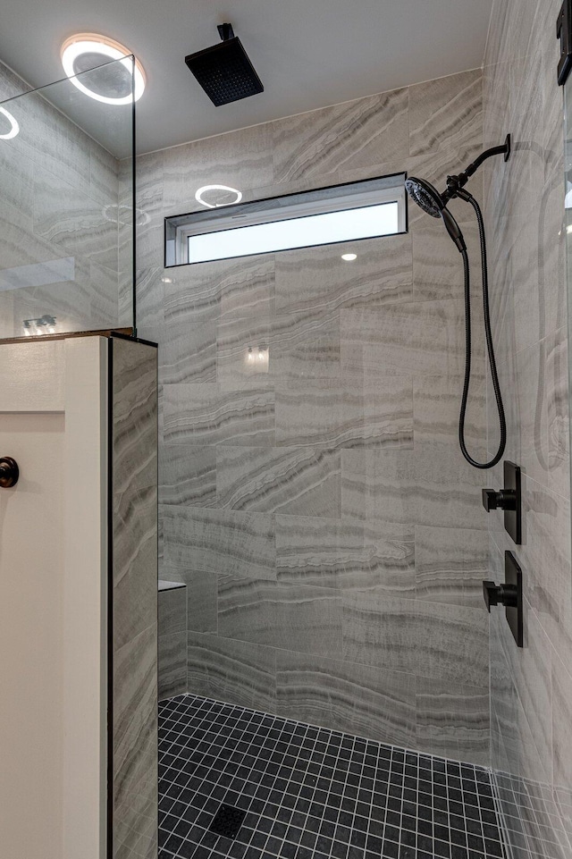 bathroom with tiled shower