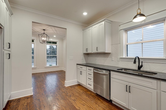 kitchen featuring backsplash, dishwasher, white cabinetry, and sink