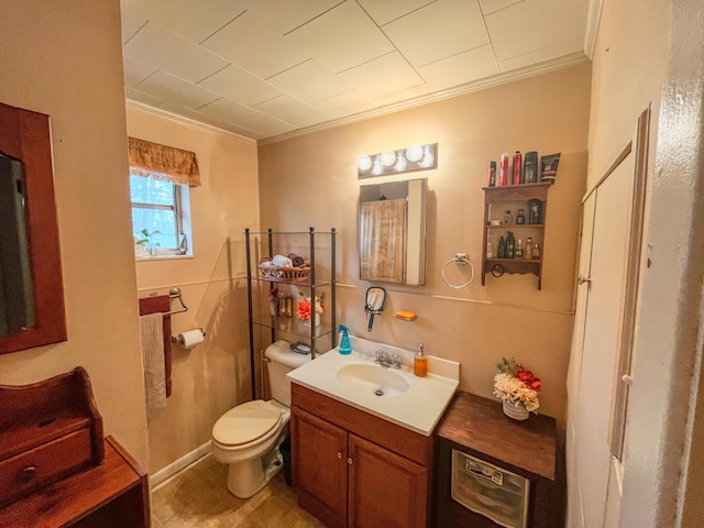 bathroom featuring crown molding, vanity, and toilet