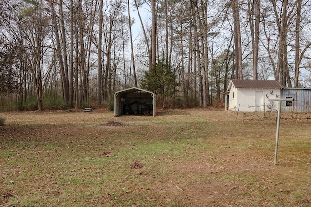 view of yard with a storage unit and a carport