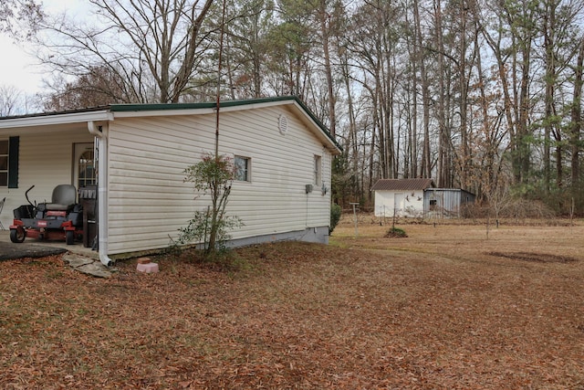 view of side of property featuring a storage unit