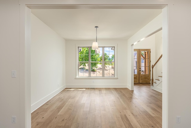 unfurnished dining area with french doors and light hardwood / wood-style flooring