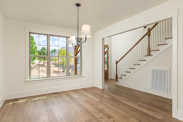 unfurnished dining area with wood-type flooring