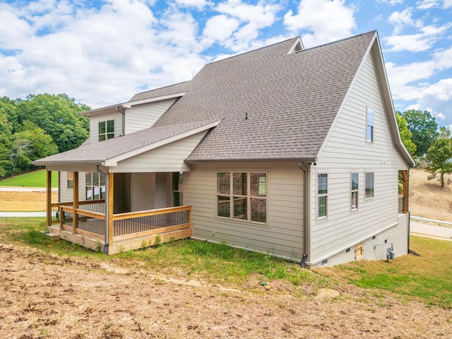 back of property with a sunroom