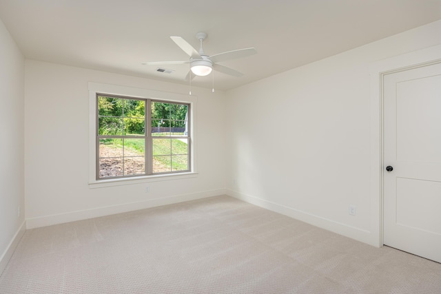 spare room featuring ceiling fan and light colored carpet