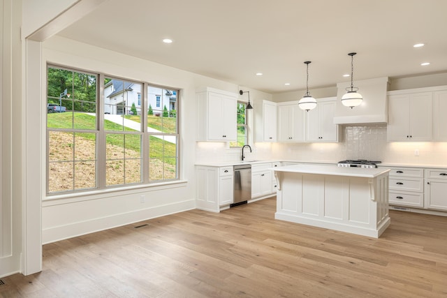 kitchen with white cabinets, a healthy amount of sunlight, and appliances with stainless steel finishes