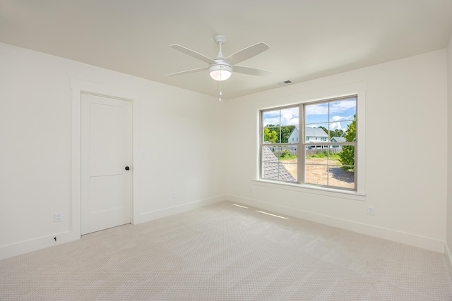 unfurnished room featuring ceiling fan and light carpet