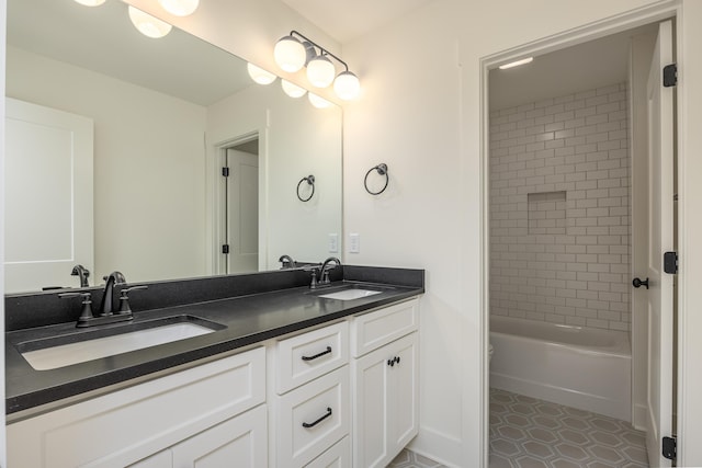 bathroom featuring vanity and tiled shower / bath