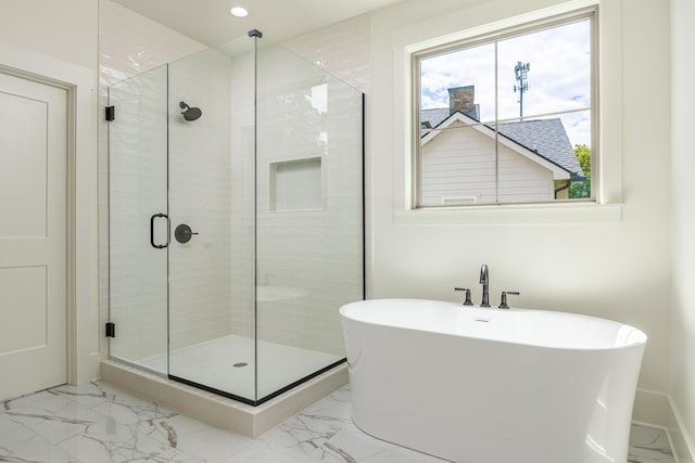 bathroom with separate shower and tub