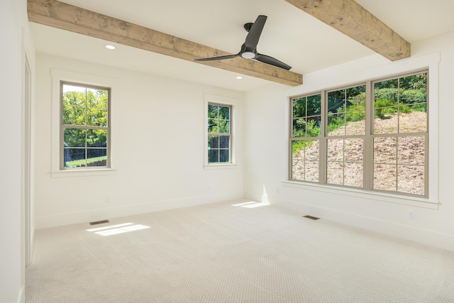 carpeted empty room with beam ceiling and ceiling fan