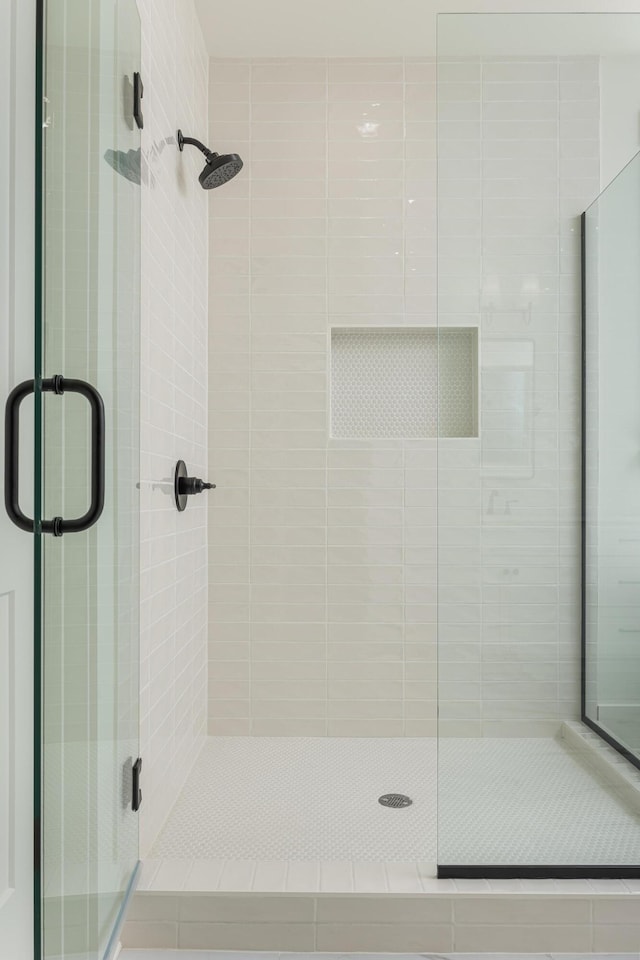 bathroom with a shower with shower door