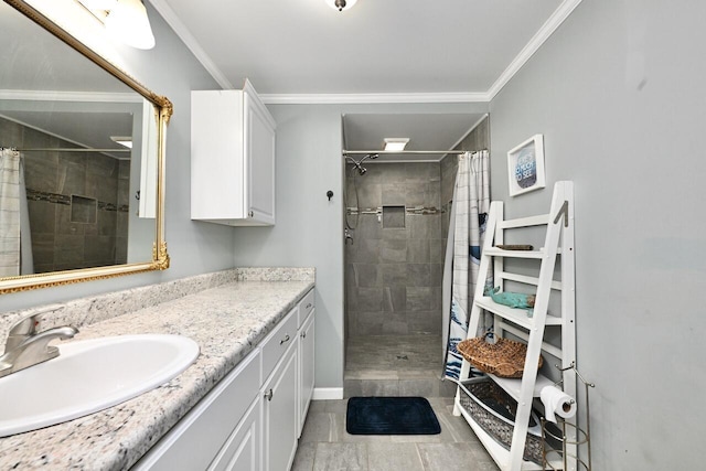 full bathroom with vanity, ornamental molding, baseboards, and tiled shower