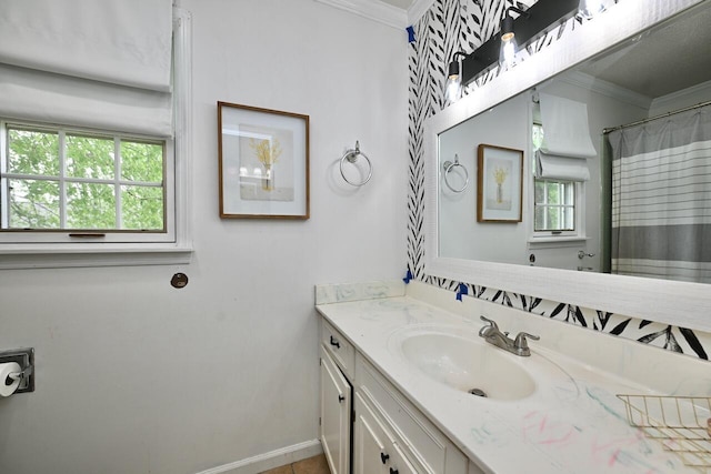 full bathroom with baseboards, ornamental molding, and vanity