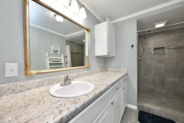 full bath featuring crown molding, baseboards, a tile shower, and vanity