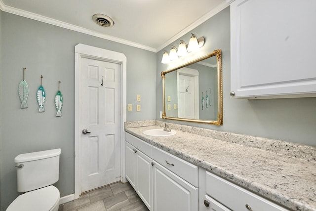 bathroom with visible vents, crown molding, vanity, baseboards, and toilet