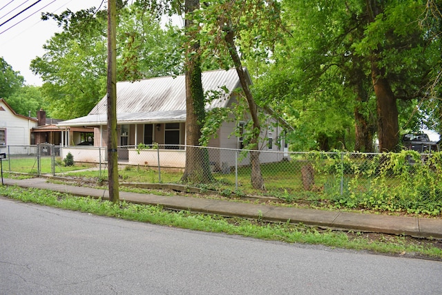 174 E Jackson Ave, Spring City, TN 37381 - view of front of house featuring a fenced front yard, metal roof, and covered porch