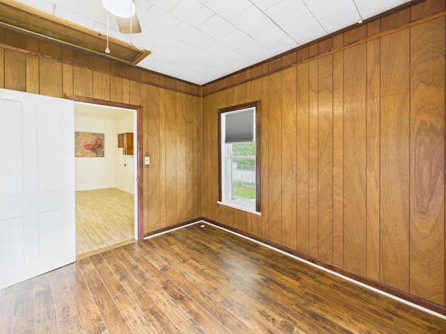174 E Jackson Ave, Spring City, TN 37381 - empty room with hardwood / wood-style flooring, wooden walls, and baseboards