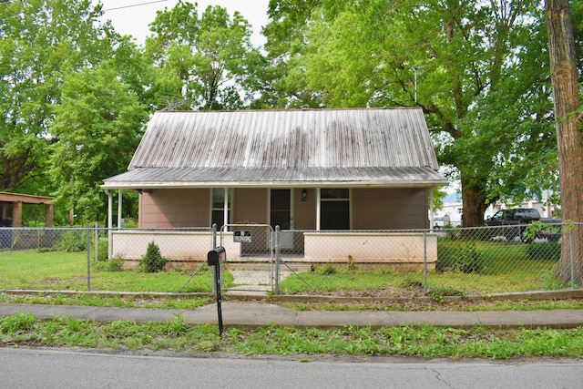174 E Jackson Ave, Spring City, TN 37381 - view of front of property with a porch, a gate, a fenced front yard, and metal roof