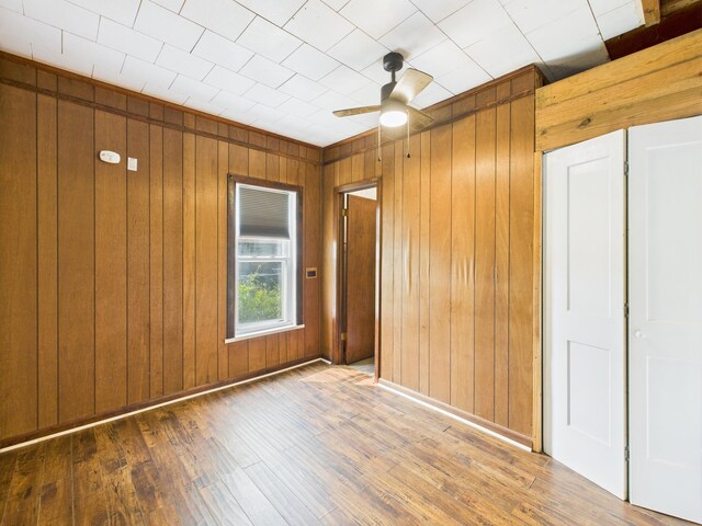 174 E Jackson Ave, Spring City, TN 37381 - spare room featuring wood walls, ceiling fan, and wood-type flooring