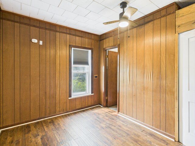 174 E Jackson Ave, Spring City, TN 37381 - unfurnished room with wooden walls, wood-type flooring, and a ceiling fan