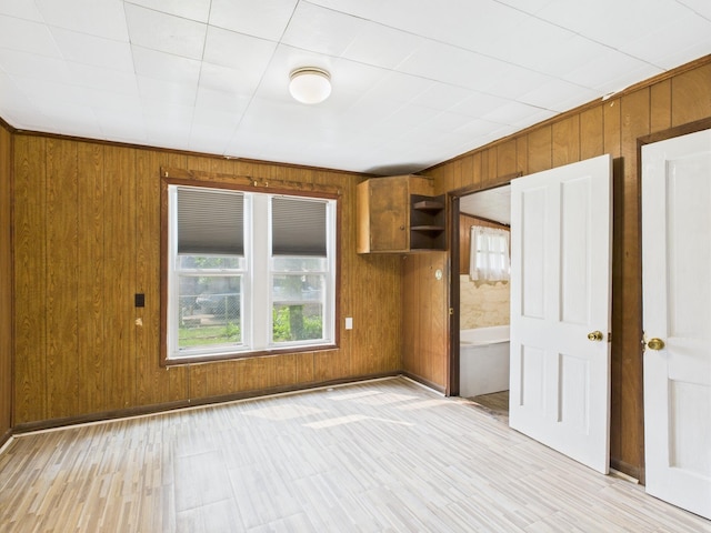 174 E Jackson Ave, Spring City, TN 37381 - spare room featuring plenty of natural light, wood walls, and light wood-style floors