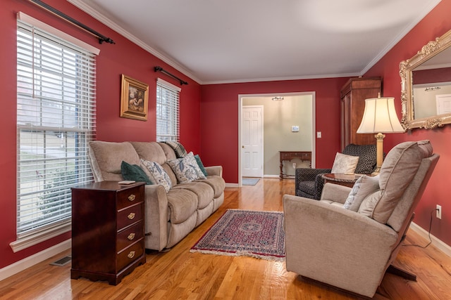 living room featuring light hardwood / wood-style flooring and crown molding