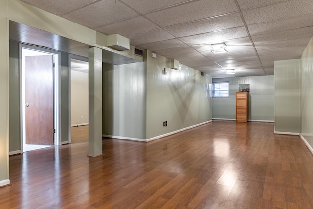 basement with hardwood / wood-style floors and a drop ceiling