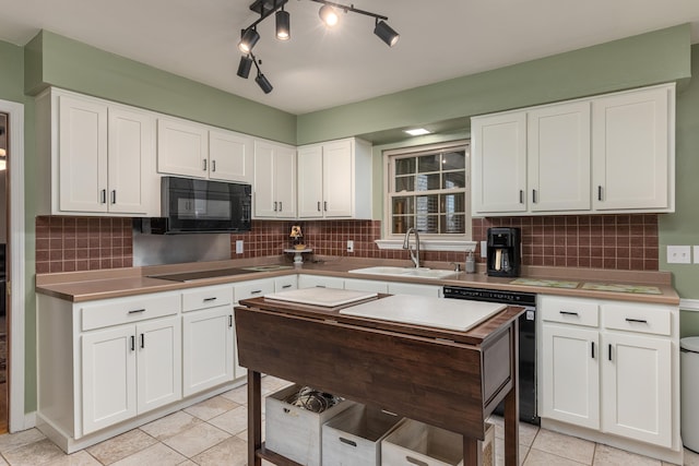 kitchen featuring white cabinets and black appliances