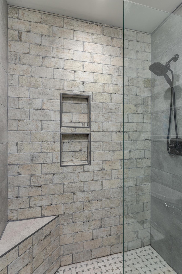 bathroom with a tile shower