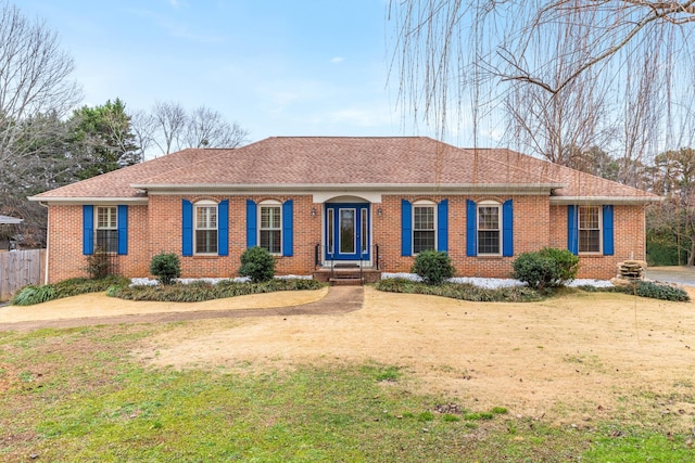 ranch-style home featuring a front yard