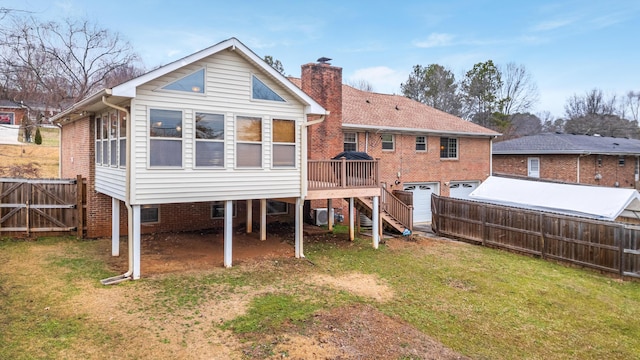 back of property featuring a lawn and a deck