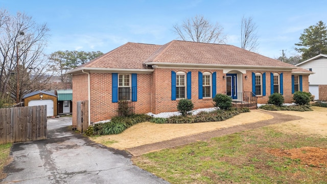 view of front facade featuring an outbuilding, a front yard, and a garage