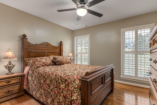 bedroom with hardwood / wood-style floors and ceiling fan