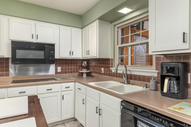 kitchen featuring decorative backsplash, sink, white cabinets, and black appliances