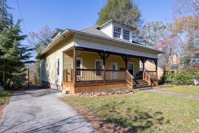 view of front of home featuring covered porch and a front yard