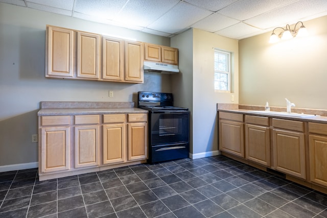 kitchen featuring dark tile patterned flooring, sink, light brown cabinetry, and black / electric stove